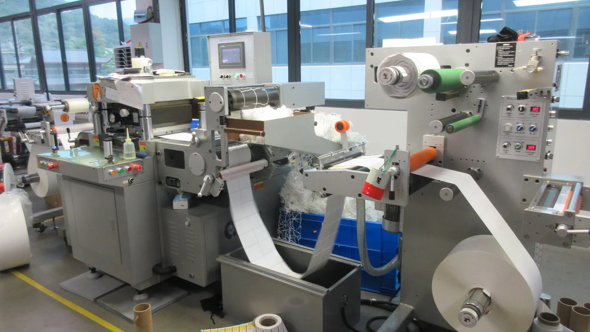 Custom roll labels moving through a factory finishing line